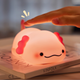 Cute lamp shaped like a cartoon character being touched by a hand on a magazine