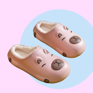Pink EVA slippers with Capybara design - lined with white plush inside. 