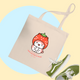 Beige tote bag with strawberry ichigo kitty character and text, paired with green sneakers on a colorful background