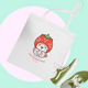 Tote bag with cartoon design and green sneakers on a light green background