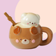 Ceramic mug shaped like a cute bear in a honey brown colour. The lid has a contrasting butter cream colour and has a 3D bear head as the handle.