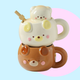 Stackable bear-shaped mugs on a colorful background, one mug is in butter cream and the other in a honey brown colour.