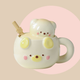 Ceramic mug shaped like a cute bear in a butter cream colour. lid has a matching colour and has a 3D bear head as the handle.