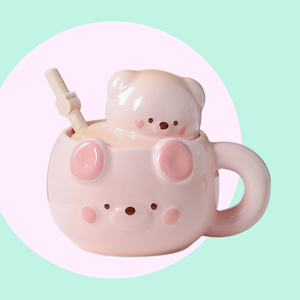Ceramic mug shaped like a cute bear in a sakura pink colour. lid has a matching colour and has a 3D bear head as the handle.