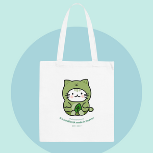 Tote bag with a green cat design and text on a light blue background