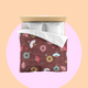 Bed with colourful fireworks in traditional Japanese pattern bedding with on a dark red, red bean background. Several designs of Japanese paper fans are dotted around