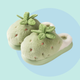 Green plushy slippers that looks like strawberries finished in green plushy leafy stalk and seeds detail. Thick shoe sole with plush lining the interior!