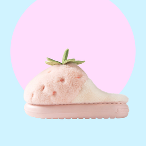 Pink plushy slippers that looks like strawberries finished in green plushy leafy stalk and seeds detail. This is the side profile of the slippers, showing how thick the sole is. 