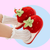 Red plushy slippers that looks like strawberries finished in green plushy leafy stalk and seeds detail. Thick shoe sole with plush lining the interior!