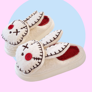 Zombie Bunny Slippers - pair of white fluffy slippers with a twisted, zombie, bunny design - marshmallowy sole with plush lined inside and out. 
