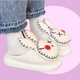 Zombie Bunny Slippers - pair of white fluffy slippers with a twisted, zombie, bunny design - marshmallowy sole with plush lined inside and out. 