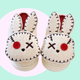 Zombie Bunny Slippers - pair of white fluffy slippers with a twisted, zombie, bunny design - marshmallowy sole with plush lined inside and out. 