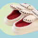 Zombie Bunny Slippers - pair of white fluffy slippers with a twisted, zombie, bunny design - marshmallowy sole with plush lined inside and out. 