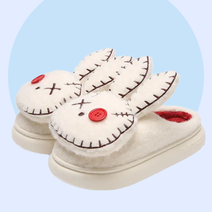 Zombie Bunny Slippers - pair of white fluffy slippers with a twisted, zombie, bunny design - marshmallowy sole with plush lined inside and out. 